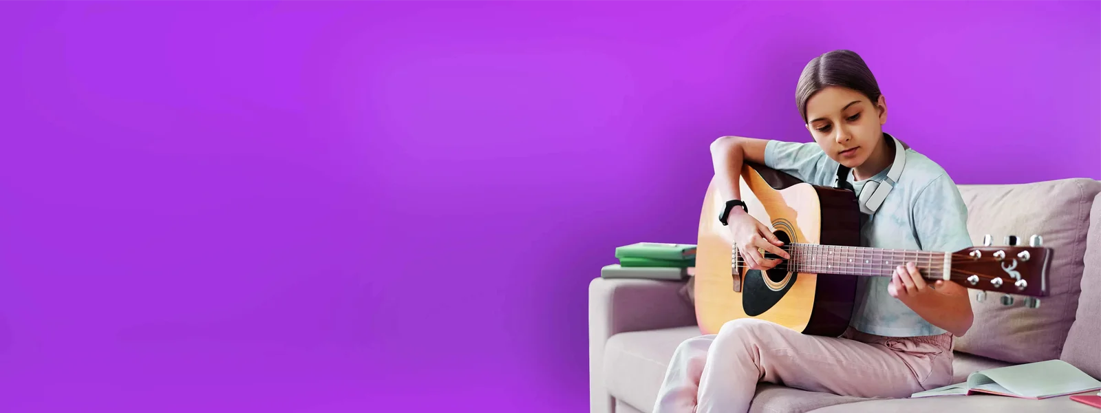 A Girl Learning to Play Guitar from Music School in Dubai