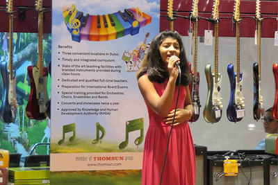 A little boy learning guitar